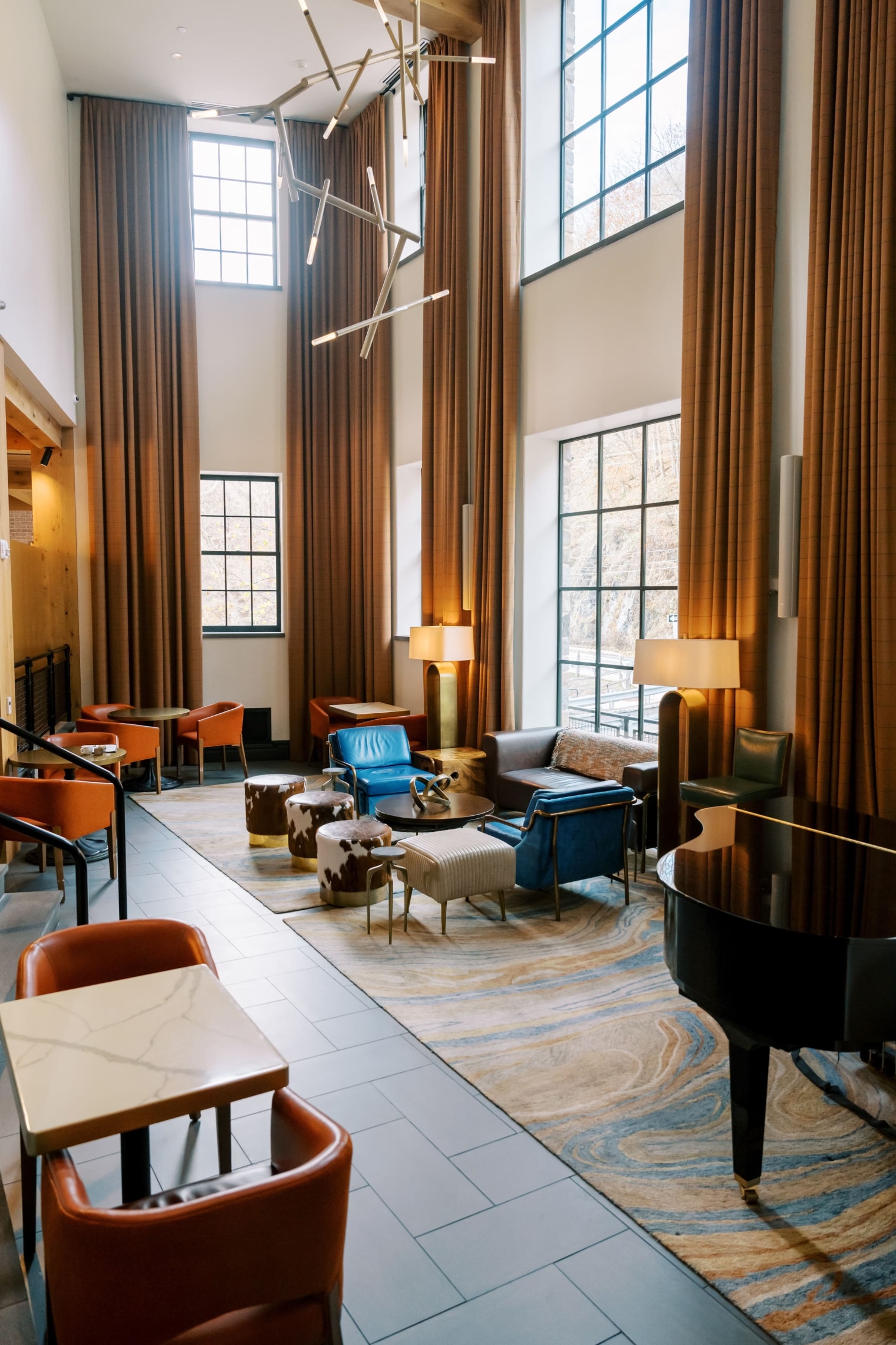 Lobby with a grand piano and sitting areas around it